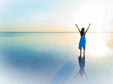 Woman standing on calm beach