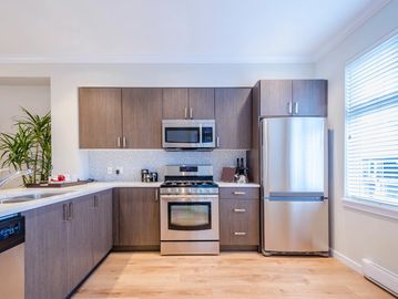Spacious and modern kitchen with stainless steel appliances, and granite countertops.