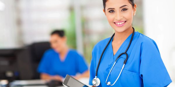 Registered nurse staff holding iPad in hands.