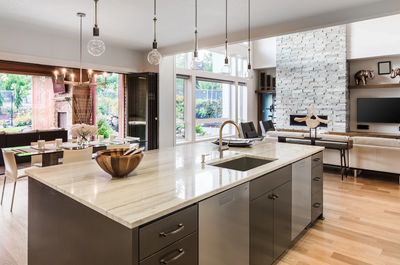 Modern kitchen with large island and open living area.