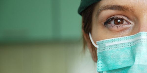 a person wearing a surgical face mask