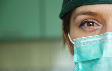 woman wearing green surgical mask