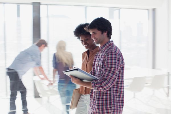 A group of people are working together in an office space.