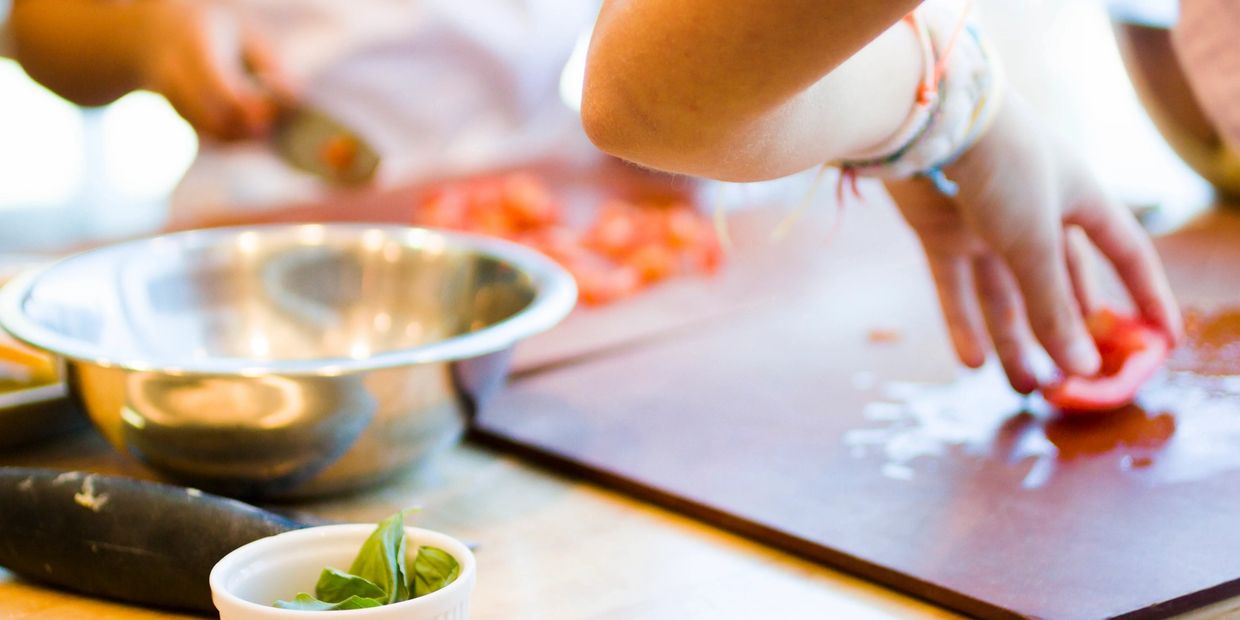 students cutting tomatoes and preparing meat