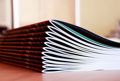 stack of printed booklets with staple at the fold or saddle stitched