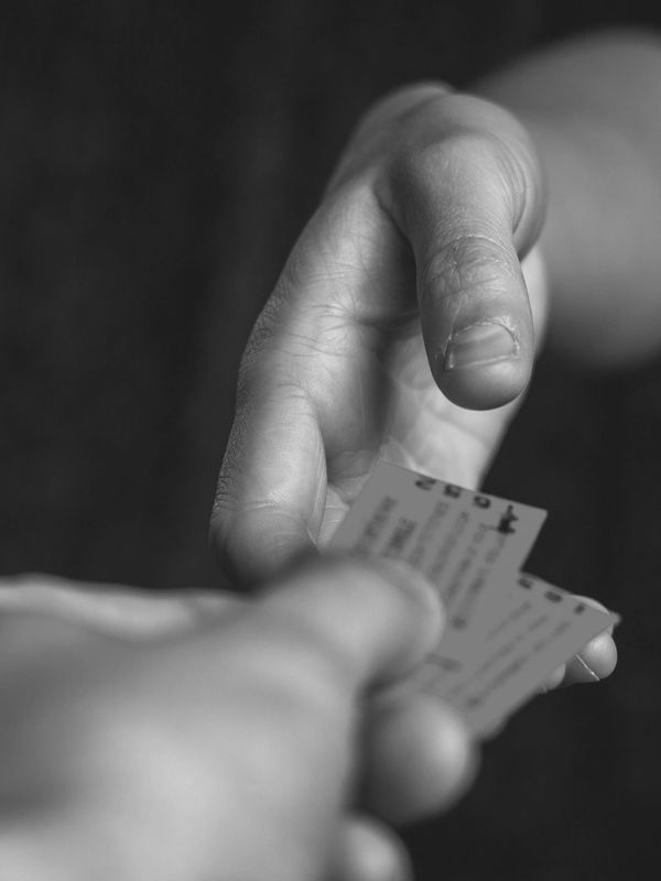 ticket stubs being passed to another