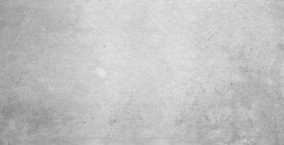 A textured gray concrete wall with subtle imperfections.