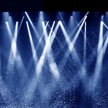 Blue stage lights with fog and particles.