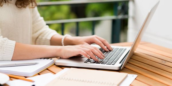 Writer typing on a laptop
