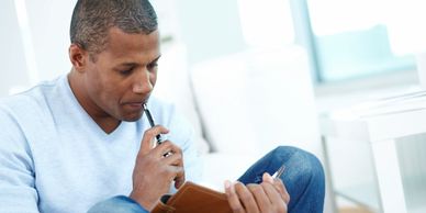 Black man thinking what to write in journal