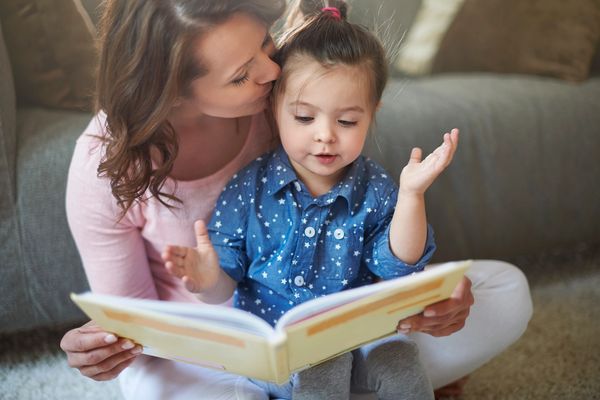 Mom reading to child on carpet after a professional carpet cleaning,