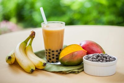 Healthy food and drink: blueberries, papaya, banana, and a healthy smoothie