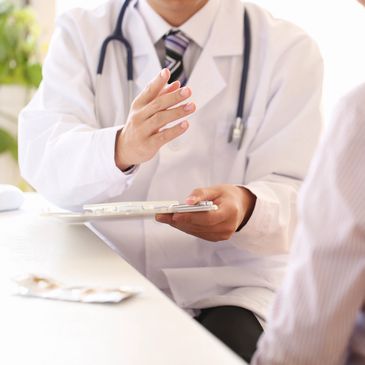 A Doctor in a White Overcoat With a Stethoscope