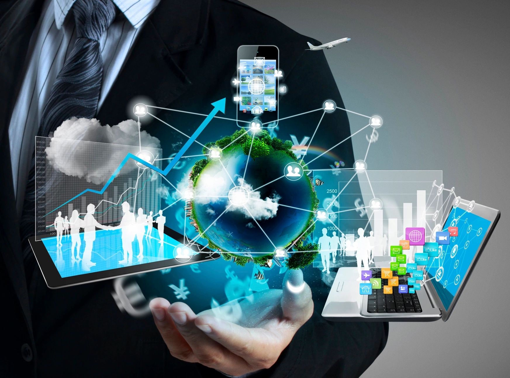 Businessman holds digital globe with network, charts, and technology icons.