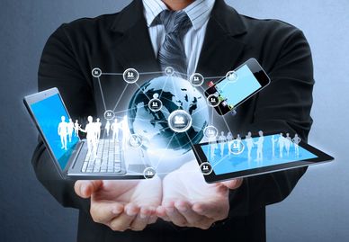 Digital devices connected by a global network held by a businessman.