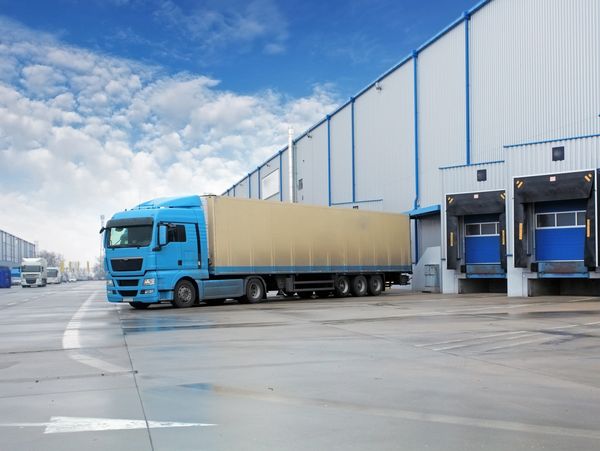 A storage warehouse with a truck in the front
