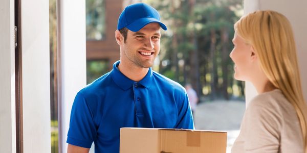 Courier delivering parcel with a smile