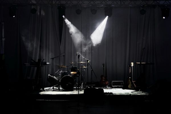 Empty stage with musical instruments and spotlights.
