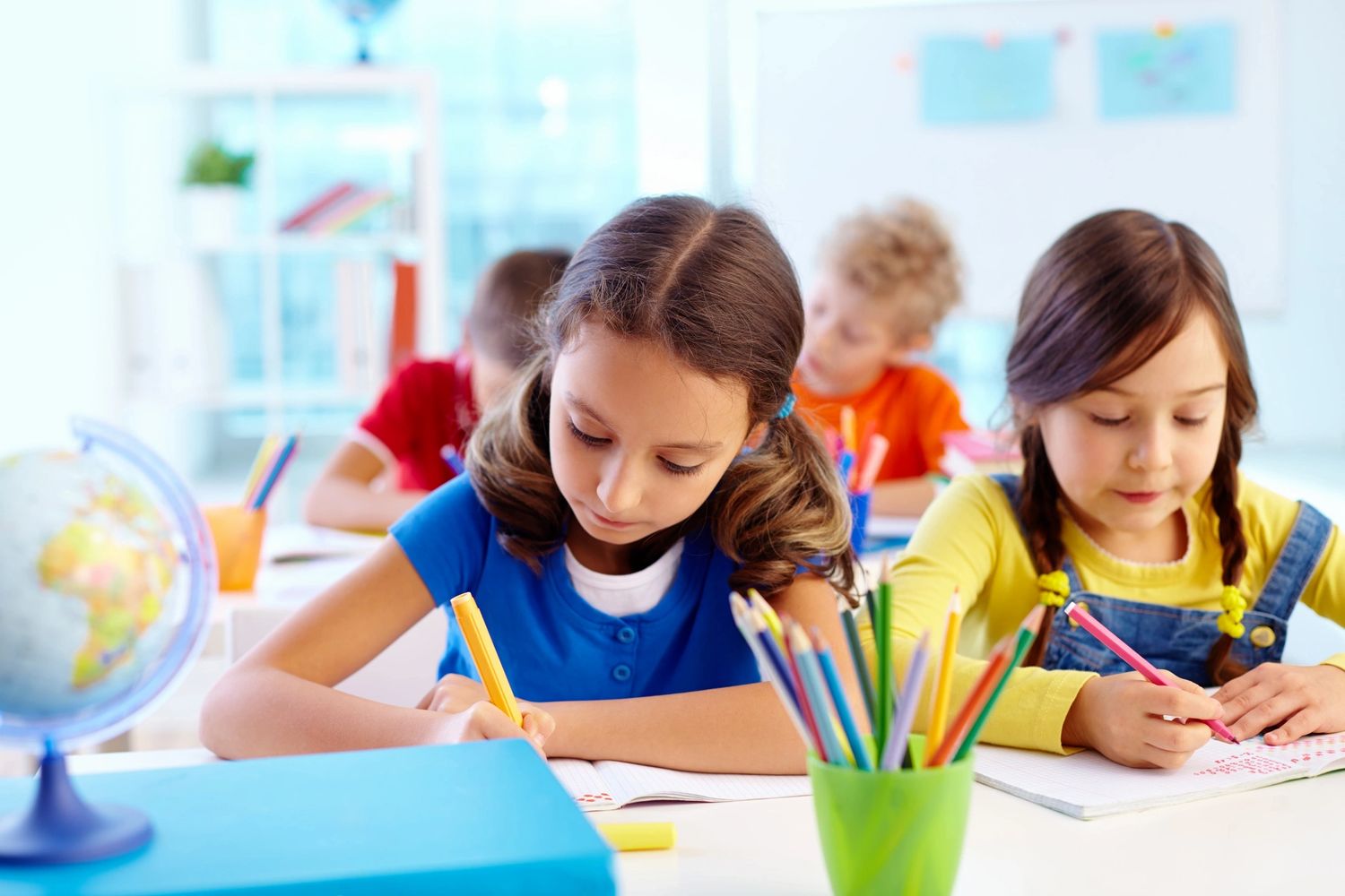Children at the table with markers on the left