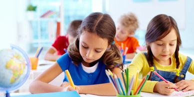 two students working with colored pencils