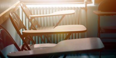 empty desks with sunshine in window