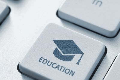 Keyboard key with education icon and text.