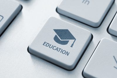 Keyboard key with education icon and text.