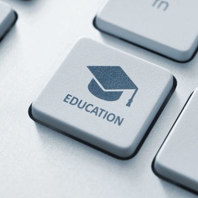 Close-up of a keyboard key with an education icon and text.