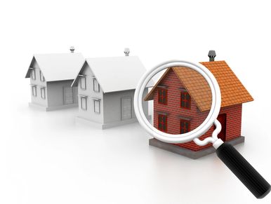 Magnifying glass highlighting a detailed brick house among simple grey houses. Calgary fine homes re