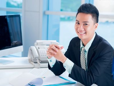 Man at Desk in Suit and Tie