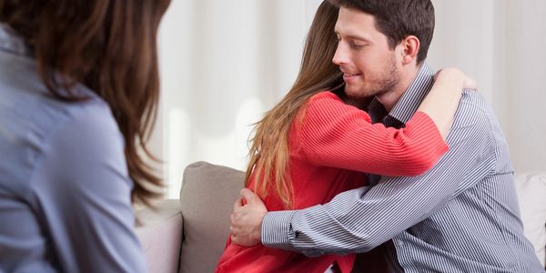 A man and a woman hugging.