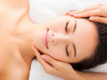 Young woman relaxing during facial treatment