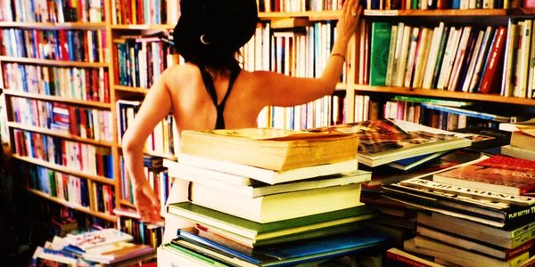 Woman in a hat shopping in a bookstore. 