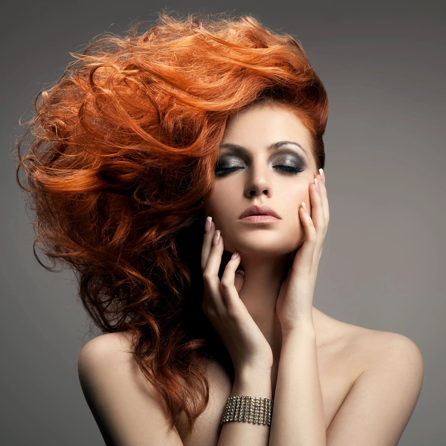 Face of female model with beautiful red hair and makeup.