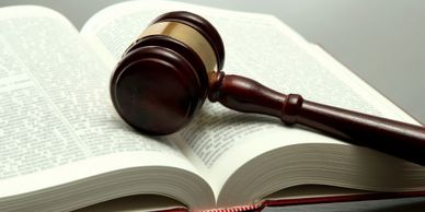 Picture of a lawbook with a judge's gavel on it 
