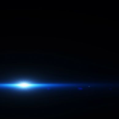 Bright blue light flare on a dark background.