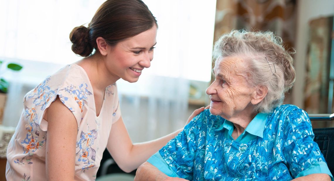 Caregiver Helps Elderly Client in  Home