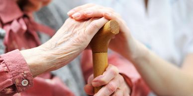 Hands holding onto the cane. 