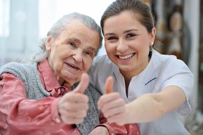 aging woman and young woman thumbs up