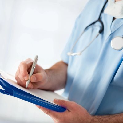 Nurse with checklist and pen. Private nurse in Bristol carrying out  a health check 