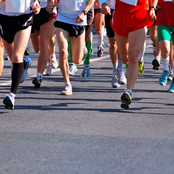 Coached athletes competing in a marathon on the roads of Noosa sunshine coast