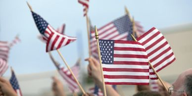 People waving multiple American flags.