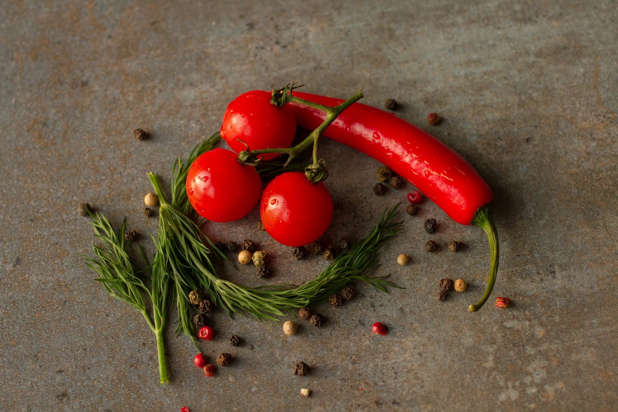 Chiles, tomatoes, and spices on a table