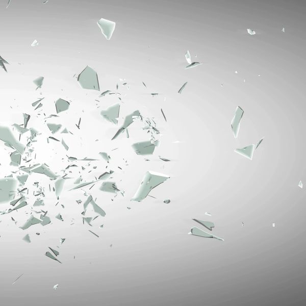 Shattered glass fragments scattered against a light background.