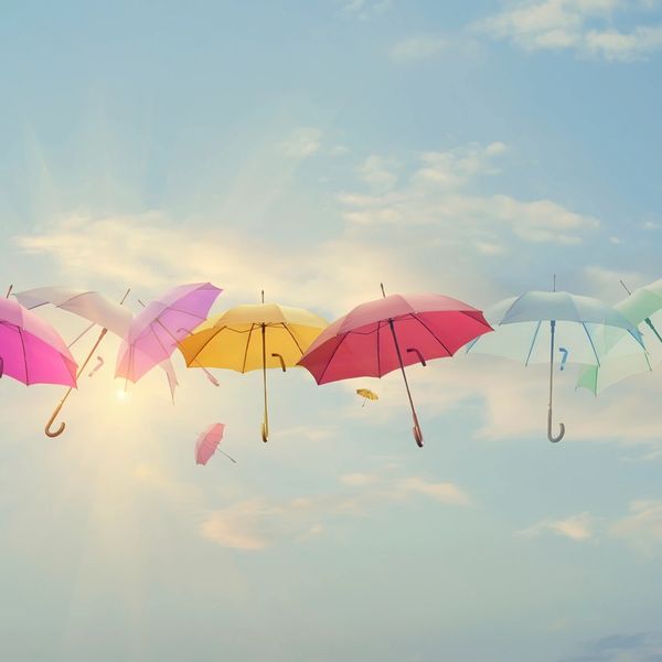 Colorful umbrellas floating in the sky