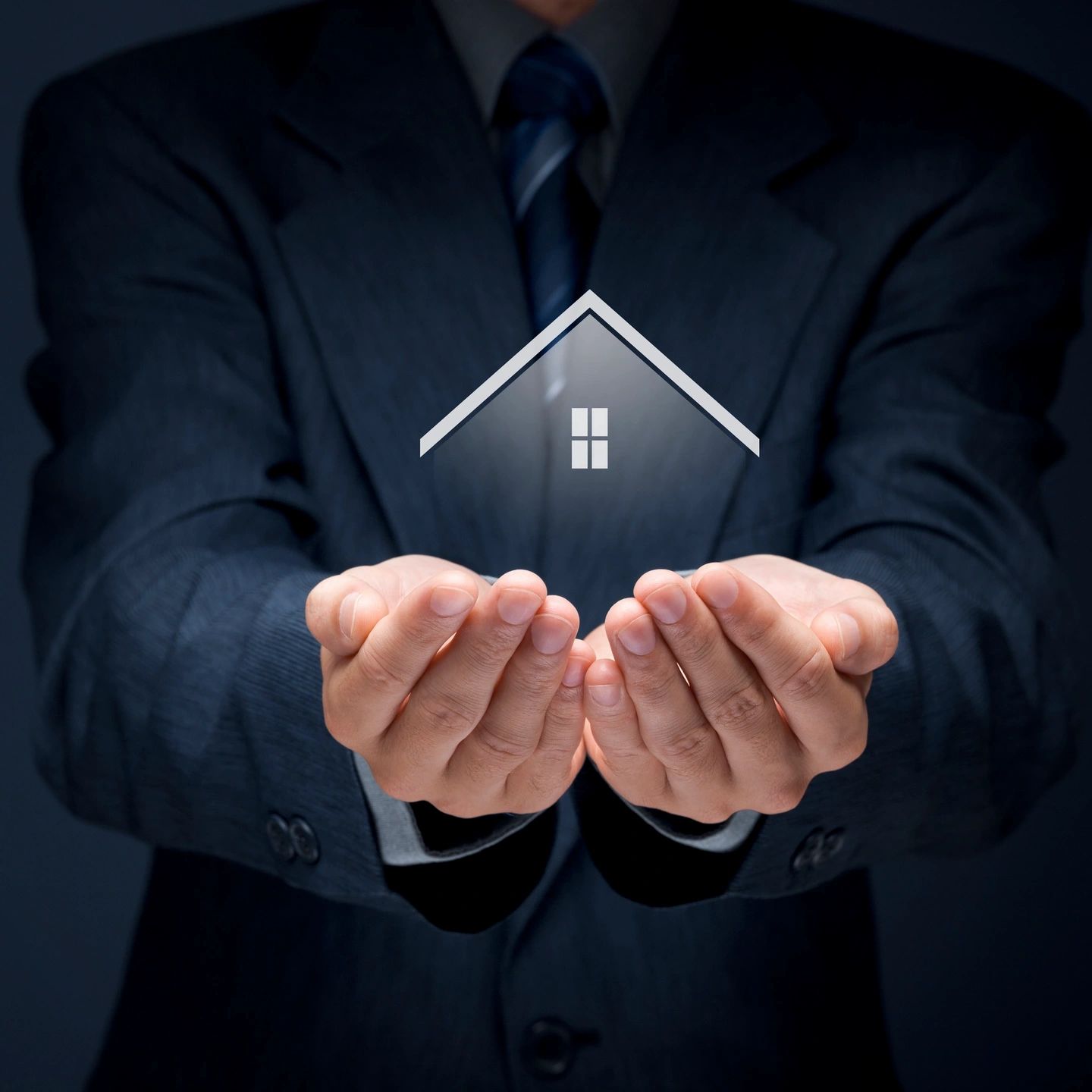 Man holding a house in the palm of his hands, in essence taking care of the property.