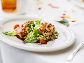 grilled chicken salad on a white plate