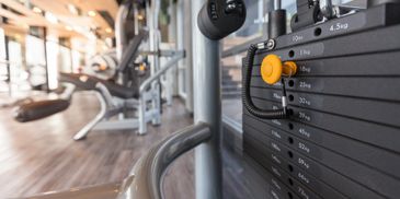 Close-up of weight stack on gym exercise machine in a fitness center.
