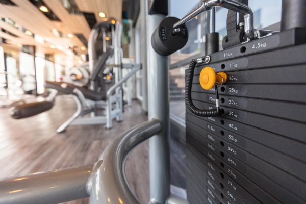 Close-up of a gym weight stack with various weight levels.