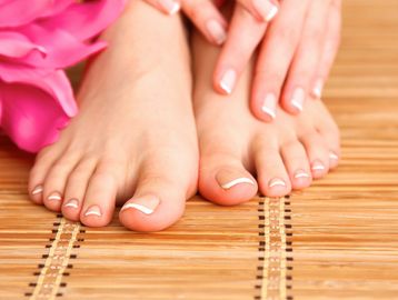 A pair of bare feet on a mat with a pink flower